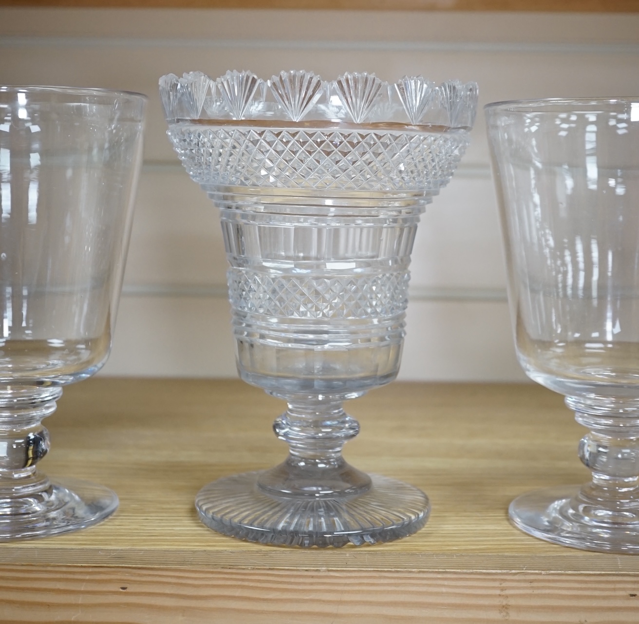 A Regency cut glass vase and a near pair of celery vases, largest 21cm high. Condition - good